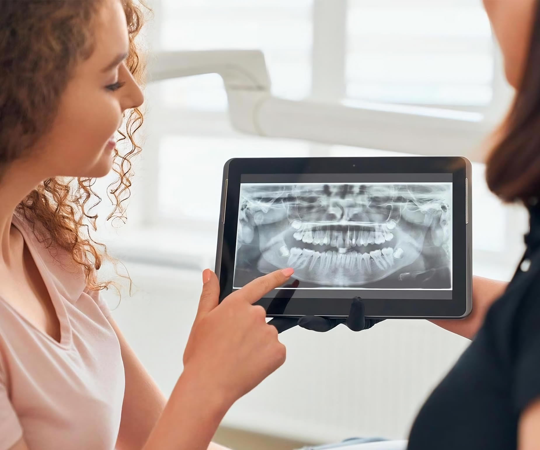 a woman showing a x-ray to another woman