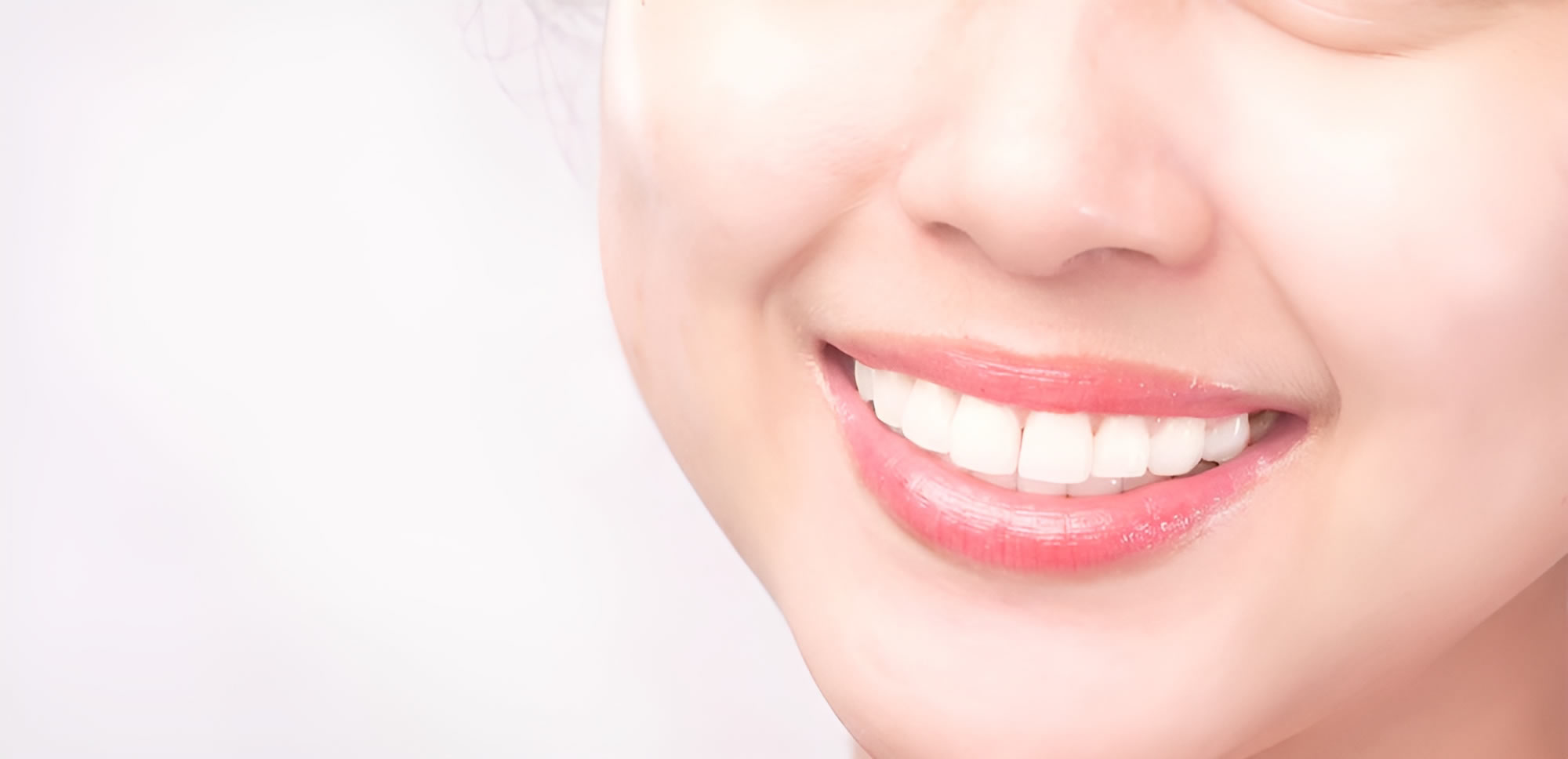 close up of a woman's face with her teeth smiling